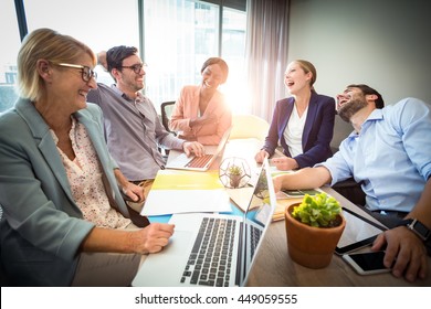 Business people laughing during a meeting in the office