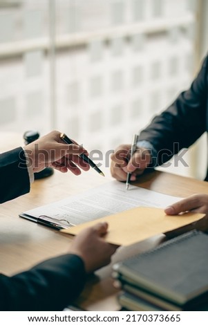 Business people or lawyers discussing contracts or business deals at a law firm. Justice advice service concept with hammer and goddess of justice beside, vertical image.