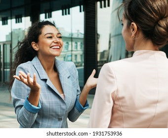 Business, People And Lifestyle Concept: Two Business Women Having A Casual Meeting Or Discussion In The City.