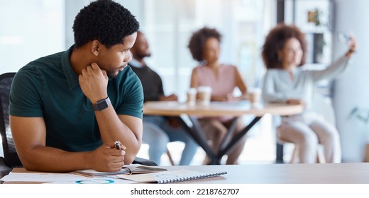 Business People, Lonely And Black Man Working In The Office While Colleagues Take Selfie. Conflict, Reject And Antisocial Businessman At Work Alone, Sad And Social Outcast In Corporate Workplace