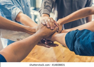 business people making pile of hands , soft focus, vintage tone - Shutterstock ID 414838831