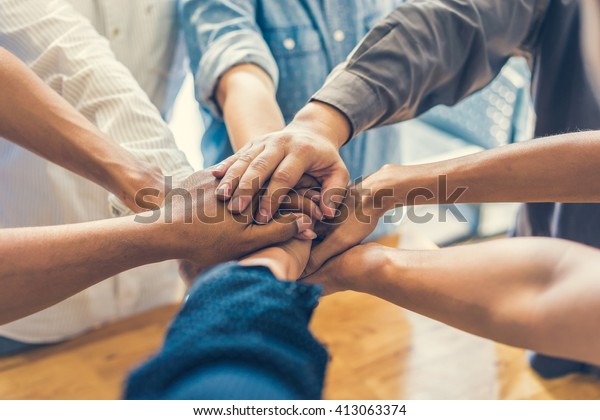 business people making pile of hands , soft focus,\
vintage tone 