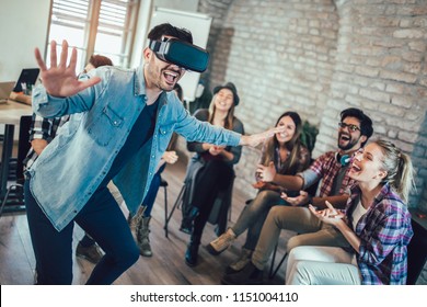 Business people making team training exercise during team building seminar using VR glasses - Powered by Shutterstock