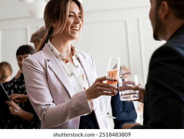 Business people making a toast at an office party, team of business people working together, business teamwork, businesswoman, team celebration - Powered by Shutterstock