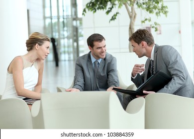 Business People Meeting In Airport Lounge