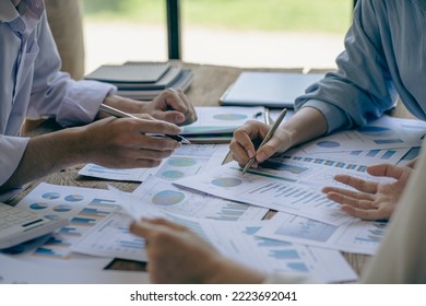 business people meeting to analyze and discuss and brainstorm data charts financial reports financial advisors Teamwork and Accounting Concepts office desk expenses - Powered by Shutterstock