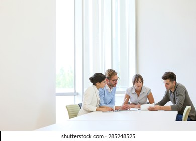 Business People Meeting Around Table In Modern Space