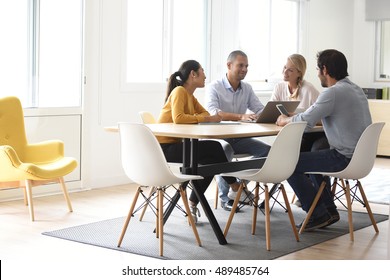 Business People Meeting Around Table In Office