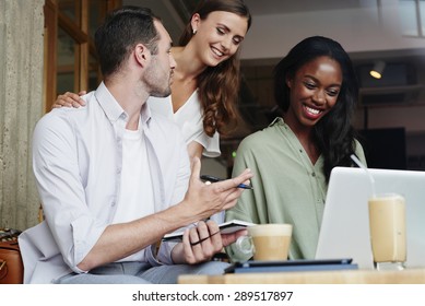 Business People Meeting In Cafe Using Laptop Drinking Coffee