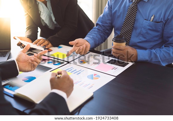 Business people meeting business consulting\
brainstorming project analysis report Check investment results And\
profits of the company