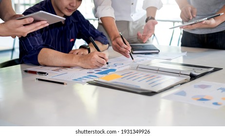 Business people meeting to find analytical ideas pointing to the graph at the office. - Powered by Shutterstock