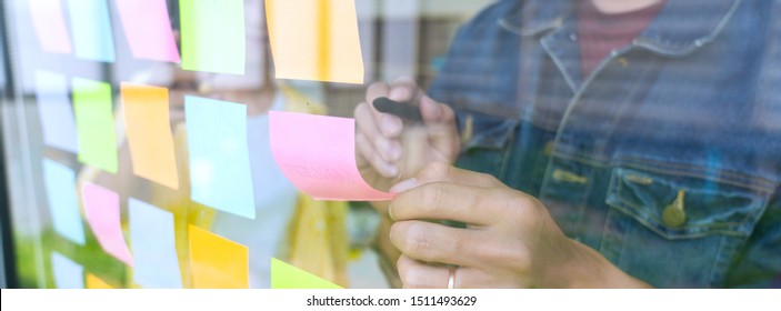 Business People Meeting At Office And Use Sticky Notes On Glass Wall In Office, Diverse Employees People Group Planning Work Together Brainstorm Strategy