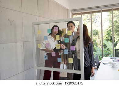 Business People Meeting At Office And Use Post It Notes To Share Idea. Brainstorming Concept. Sticky Note On Glass Wall.