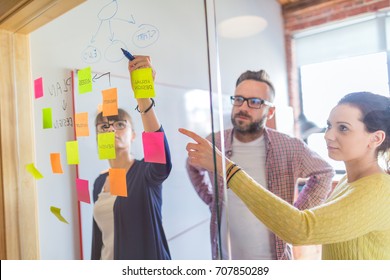 Business people meeting at office and use post it notes to share idea. Brainstorming concept. Sticky note on glass wall. - Shutterstock ID 707850289