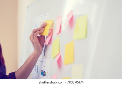 Business people meeting at office and use post it notes to share idea. Brainstorming concept. Sticky note on glass wall.business women working and communicating together in creative office - Shutterstock ID 793870474