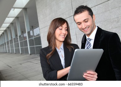 Business People Meeting Outside With Electronic Tablet