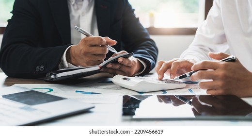 Business people meeting and planning business strategies together in the office. Financial advisor and accounting concept - Shutterstock ID 2209456619