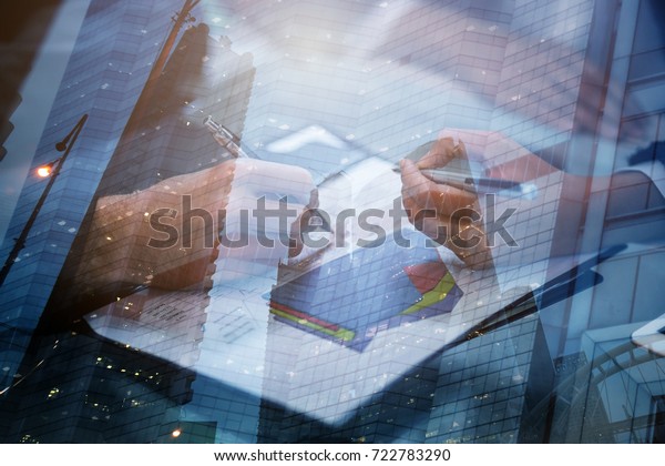 Business people meeting signing agreement sitting\
at desk team work group on conference discussing financial diagram\
graph business charts