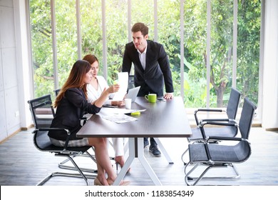 Business People Meeting And Sitting In Office Room With Green Trees Background From Window View