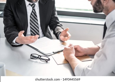 Business people negotiating a contract. Human hands working with documents at desk and signing contract. - Shutterstock ID 1493445569