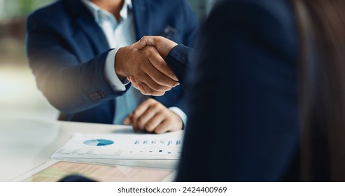 Business people, negotiation and handshake for deal, agreement or partnership in office. Shaking hands, closeup and hiring offer for recruitment, b2b collaboration or data analyst at table in meeting - Powered by Shutterstock