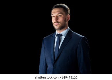 Business, People And Office Concept - Buisnessman In Suit Over Black Background