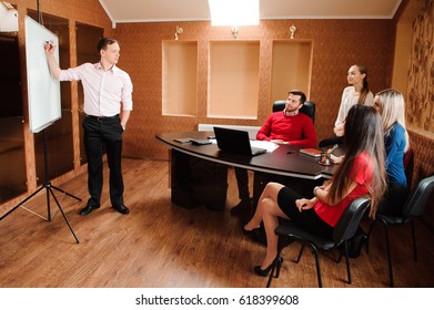 Business people in office holding a conference and discussing strategies - Shutterstock ID 618399608