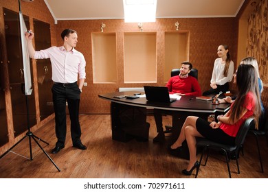 Business people in office holding a conference and discussing strategies - Shutterstock ID 702971611