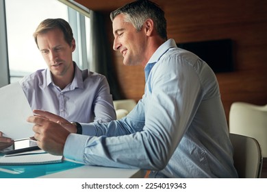 Business people, office meeting and talking about documents, corporate planning and strategy. Men together for collaboration, teamwork and partnership with paperwork, idea and vision for growth - Shutterstock ID 2254019343