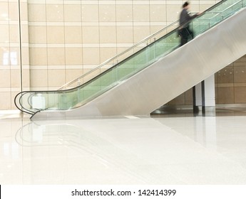 Business People On Escalator. Blurred Motion