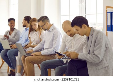 Business people on seminar training discussing in pairs making tasks together using laptops. Working and educational brainstorming process in international company. Adult education concept. - Shutterstock ID 2259101721
