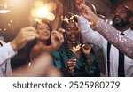 Business people, party and sparklers at night for celebration, diversity and happy for new year countdown. Women, men and smile for friends with fireworks, connection or cheers in group at gala event