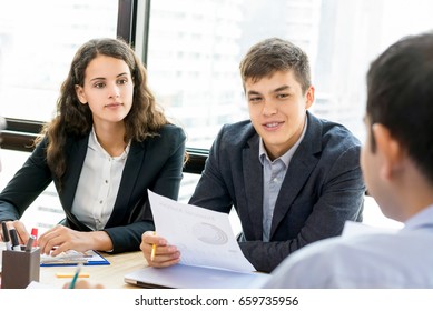 Business People Paying Attention To Their Colleague In The Meeting