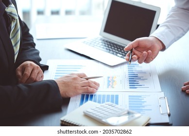 business people photo The feasibility of the project is being analyzed. with documents placed on the table and laptop - Shutterstock ID 2035702862