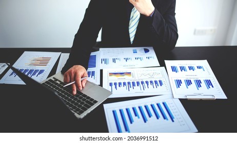 business people photo The feasibility of the project is being analyzed. with documents placed on the table and laptop - Shutterstock ID 2036991512