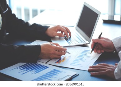 business people photo The feasibility of the project is being analyzed. with documents placed on the table and laptop - Shutterstock ID 2036991515