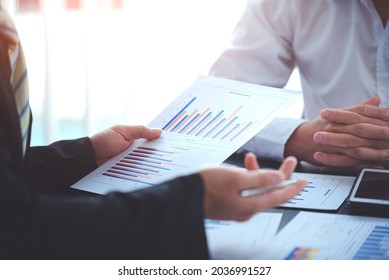 business people photo The feasibility of the project is being analyzed. with documents placed on the table and laptop - Shutterstock ID 2036991527
