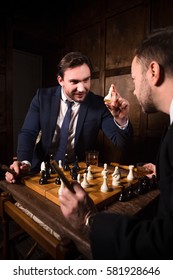 Business people playing chess demonstrating rivalry or competition between their enterprises, firms, companies. Business concept.