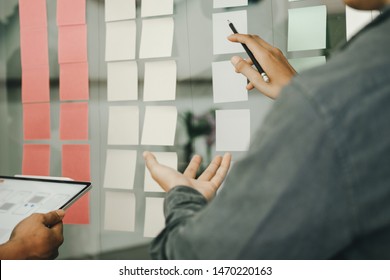 Business People Post It Notes In Glass Wall At Meeting Room, Teamwork Concept
