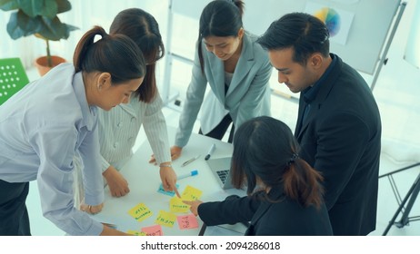 Business people proficiently discuss work project on meeting table . Corporate business team collaboration concept . - Shutterstock ID 2094286018