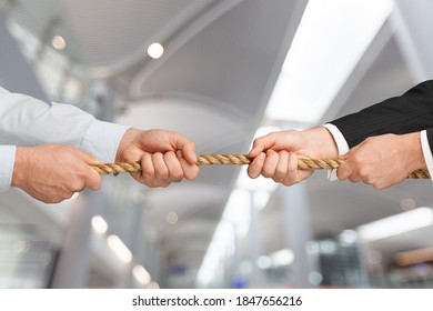 Business People Pulling Rope In Opposite Directions