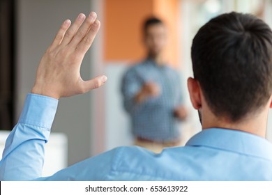 Business People Raising There Hand Up At A Conference To Answer A Question