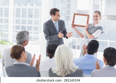 Business people receiving award in meeting room