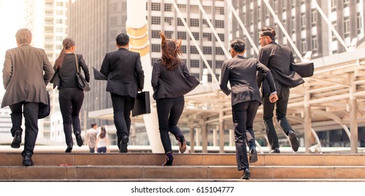 Business People Running In City 