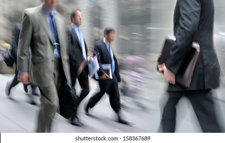 Business People At Rush Hour Walking In The Street, In The Style Of Motion Blur