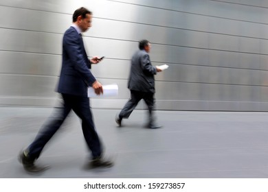 Business People At Rush Hour Walking In The Street, In The Style Of Motion Blur