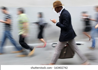 Business People At Rush Hour Walking In The Street, In The Style Of Motion Blur