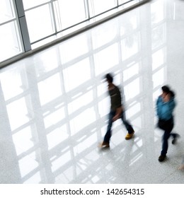 Business People Rushing In The Lobby. Motion Blur