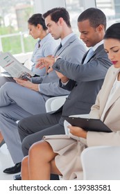 Business People Sat In Line In A Waiting Room