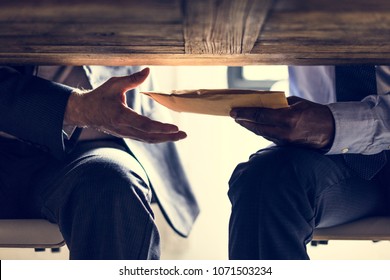 Business People Sending Documents Under The Table